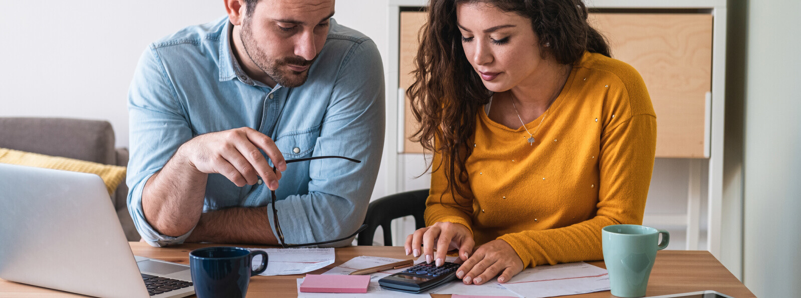 A couple looking and using a calculator