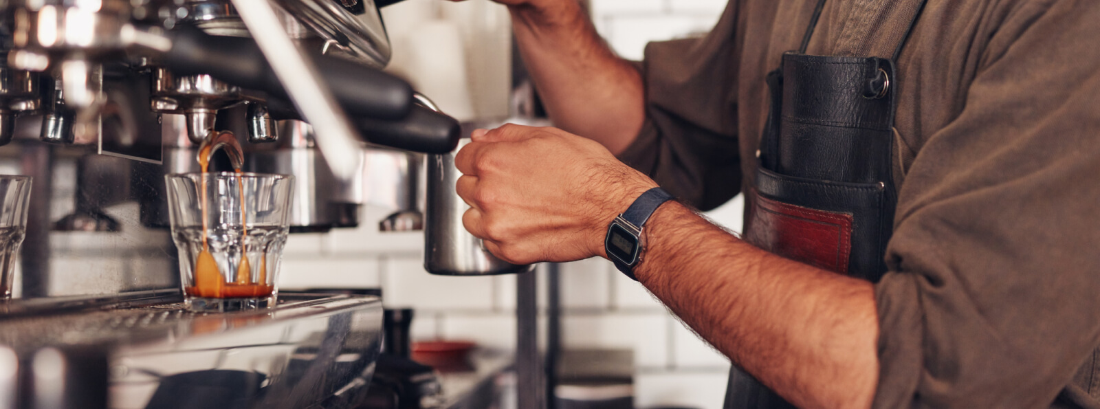 Close up of a person's hands using an espresso machine